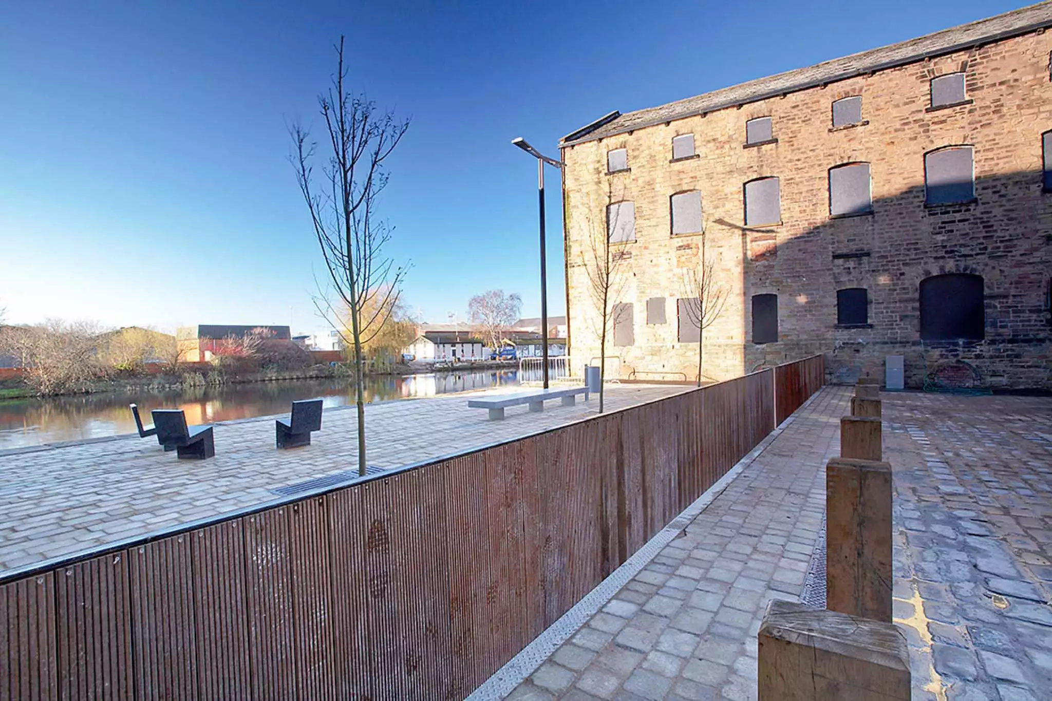 Flip-up Flood Prevention Barrier Clad in Wood, Raised to Protect Waterfront at Wakefield